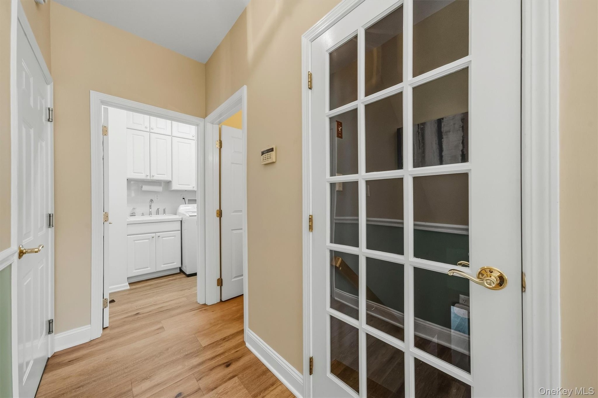 Wood-finish flooring throughout, with white trim and paneled doors