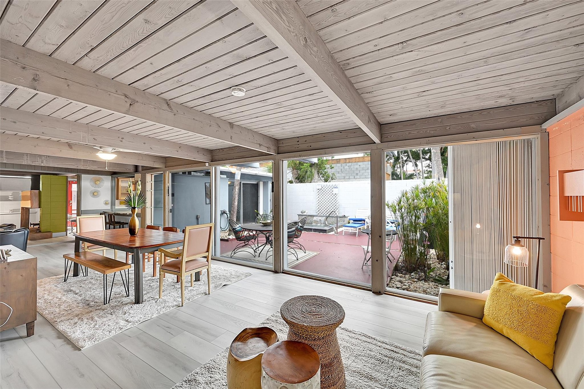extra living area open to dining area with view of patio