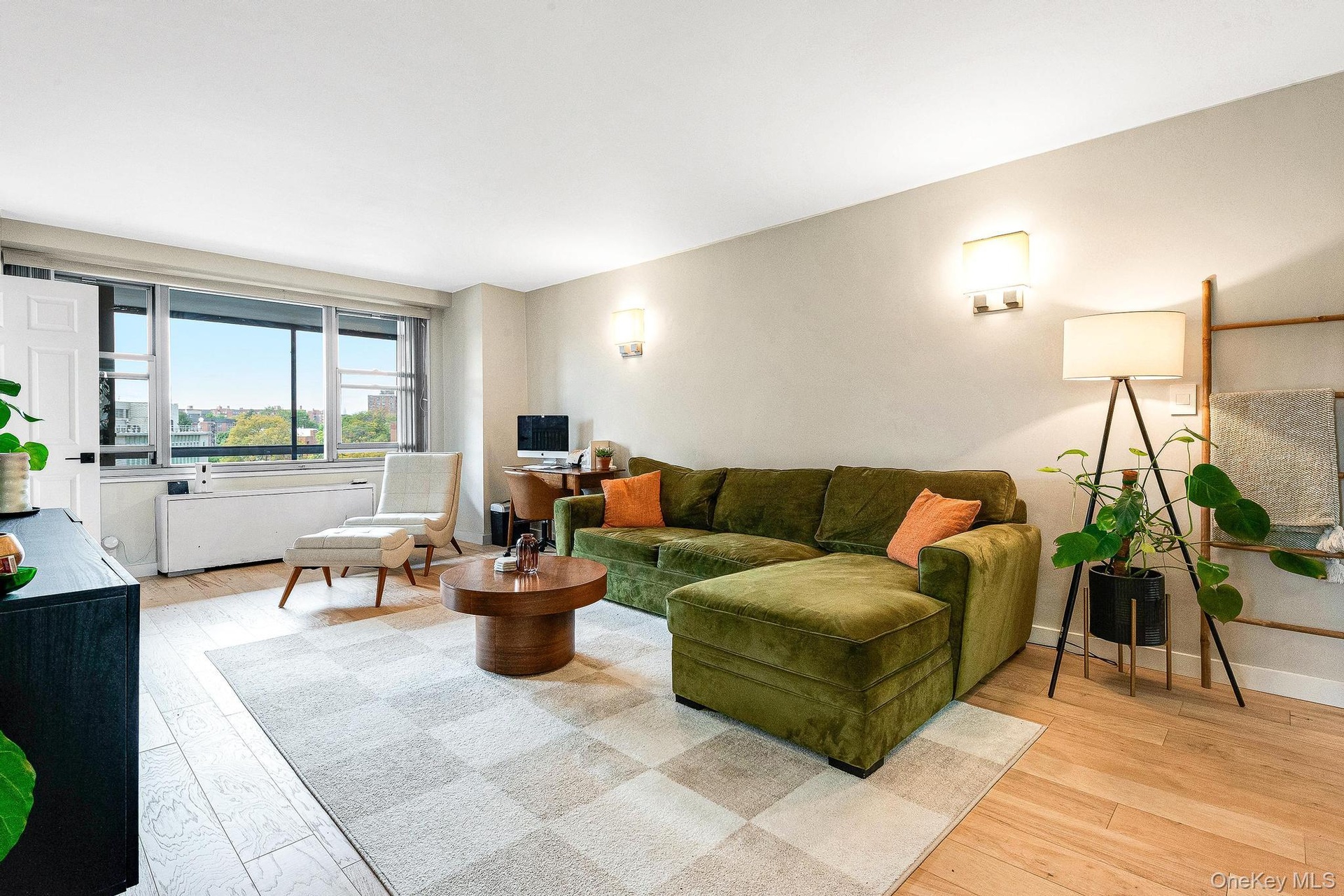 Living area with light wood-style floors and baseboards