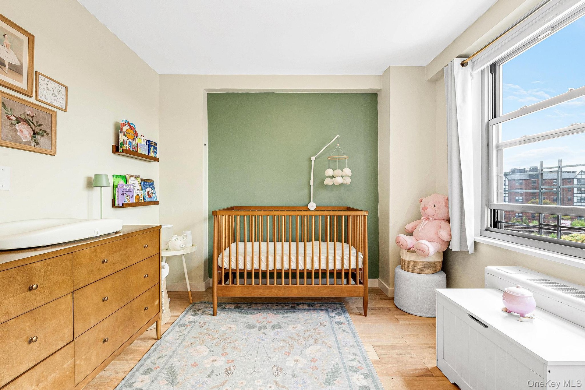 Bedroom featuring a crib and light wood-style flooring