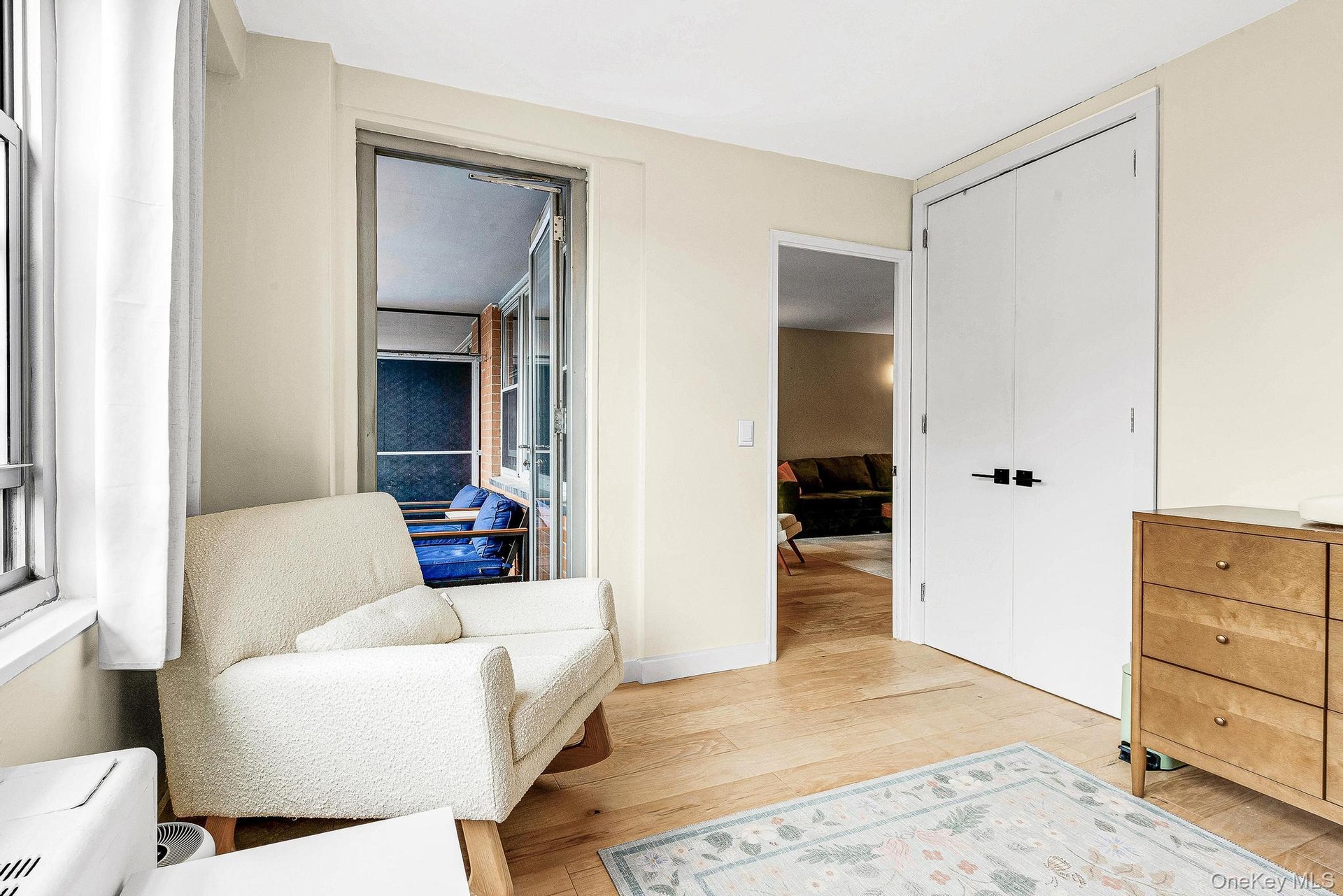 Living area with light wood-style flooring and baseboards