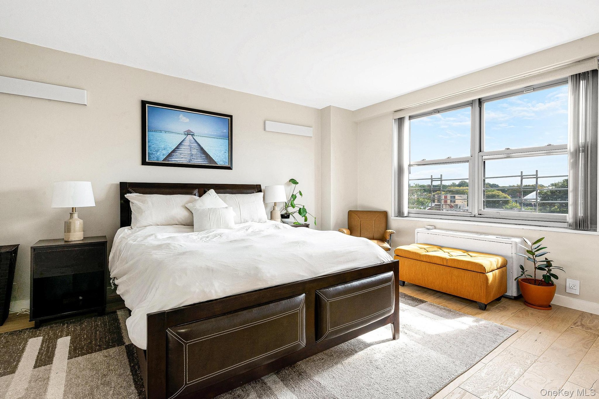 Bedroom with baseboards and wood finished floors