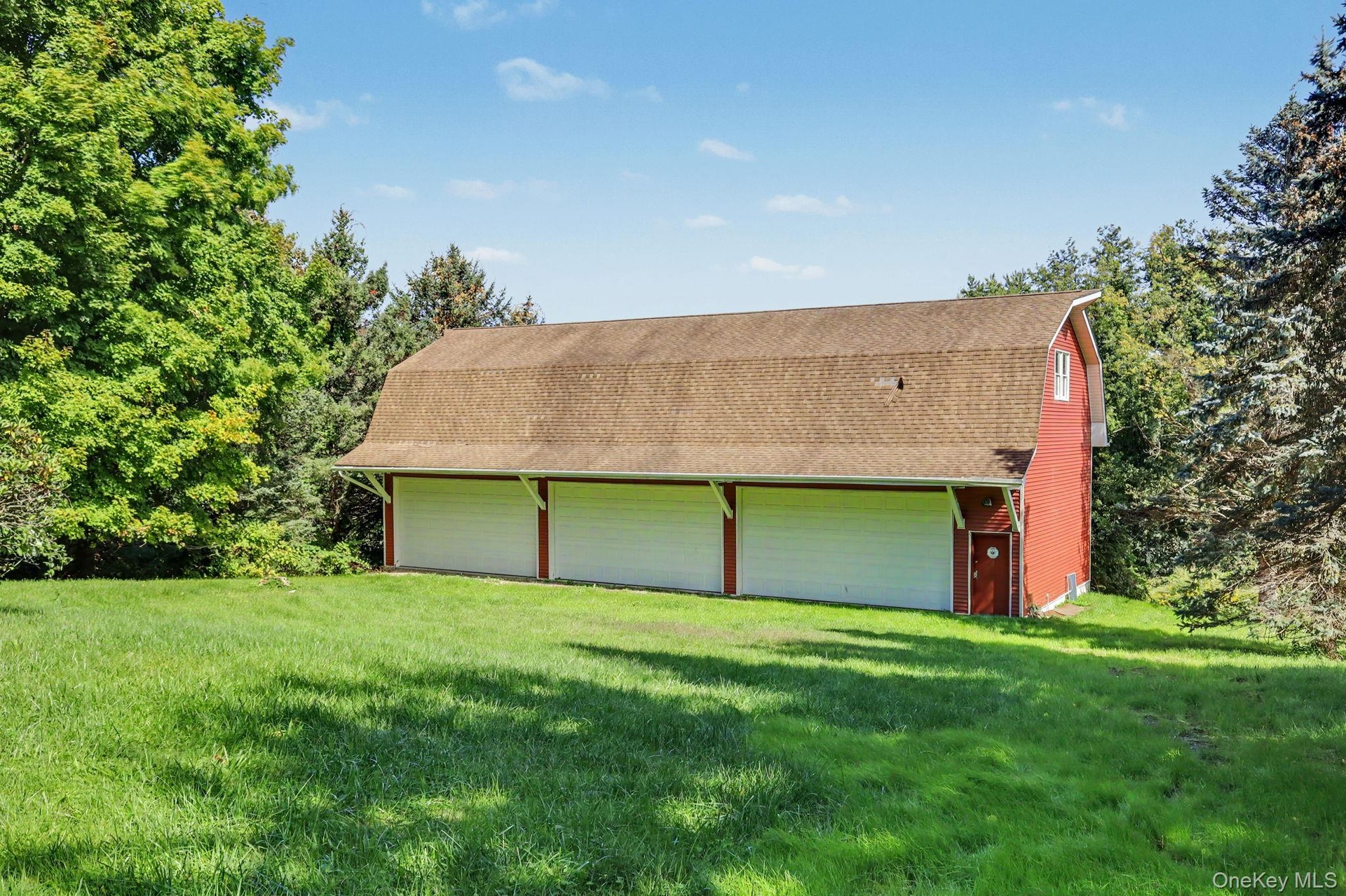 Detached six-car garage and barn (70' x 27') and each garage bay is 10' high x 20' wide.  Garage and barn has a full pine staircase which leads to the