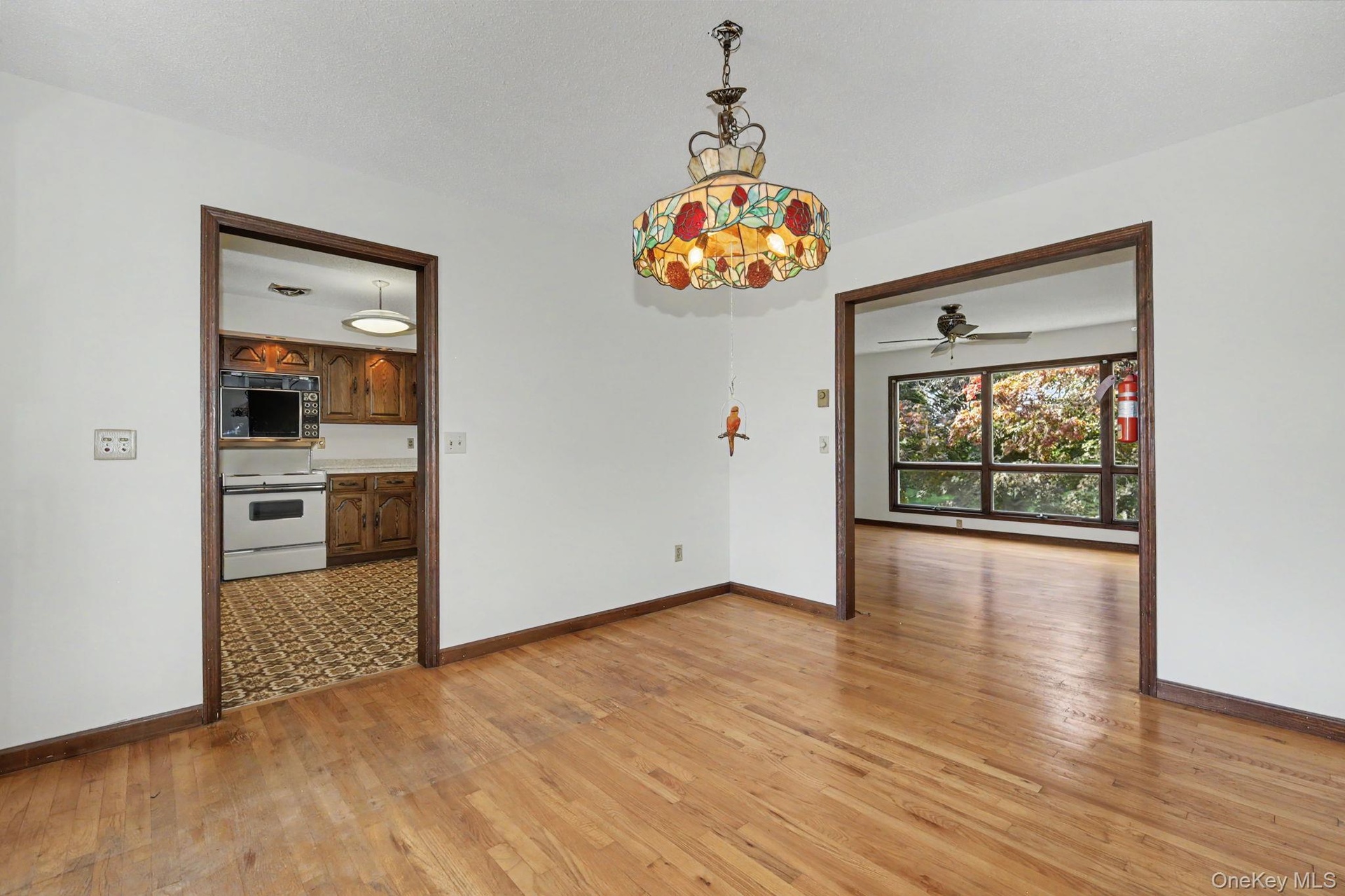 Dining room with hard wood floors leading to kitchen and living room