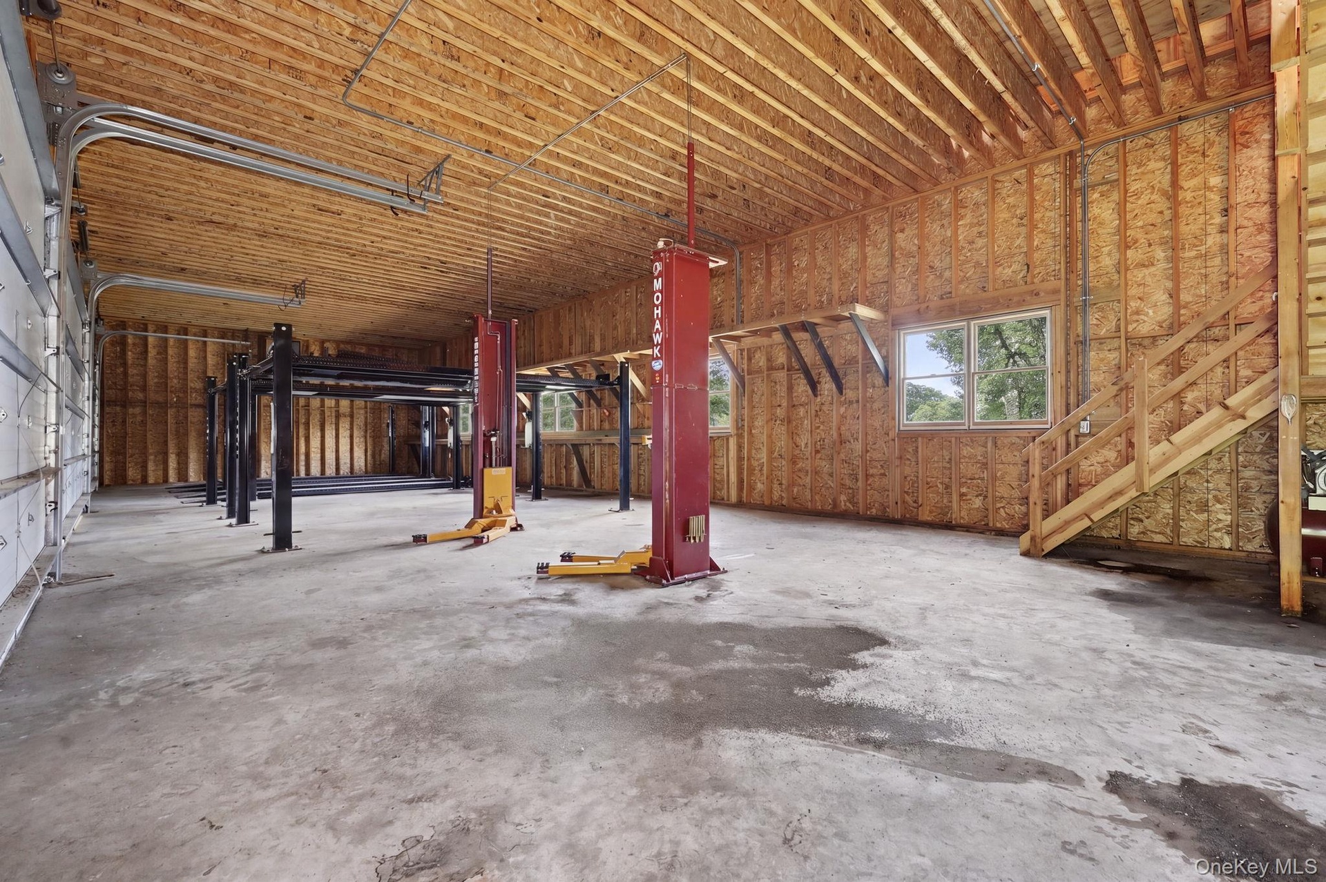 Detached six-car garage and barn (70' x 27') and each garage bay is 10' high x 20' wide.  Garage and barn has a full pine staircase which leads to the