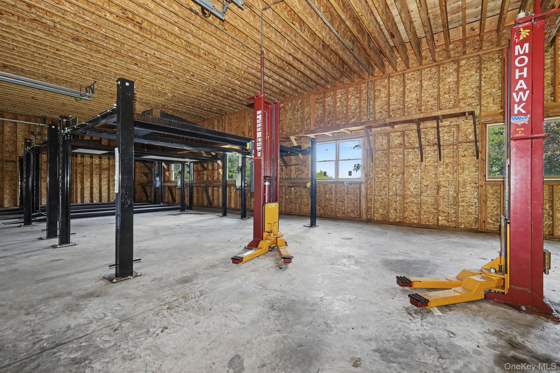 Detached six-car garage and barn (70' x 27') and each garage bay is 10' high x 20' wide.  Garage and barn has a full pine staircase which leads to the