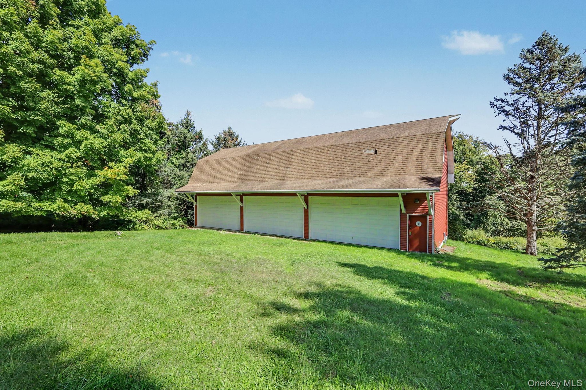 Detached six-car garage and barn (70' x 27') and each garage bay is 10' high x 20' wide.  Garage and barn has a full pine staircase which leads to the