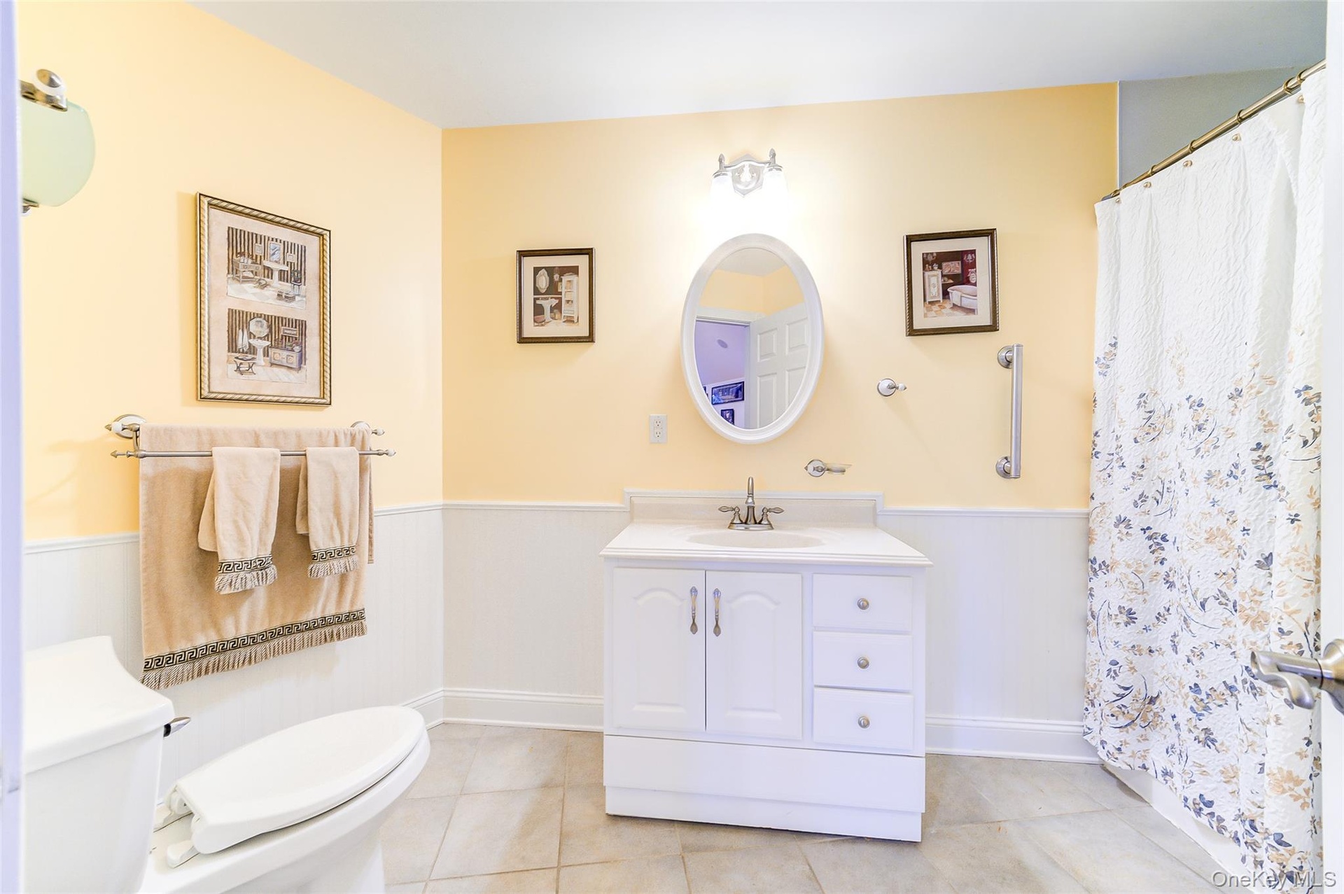 Full bathroom, just off of Bonus Room features a white stone topped vanity,. full tub/shower and tiled flooring
