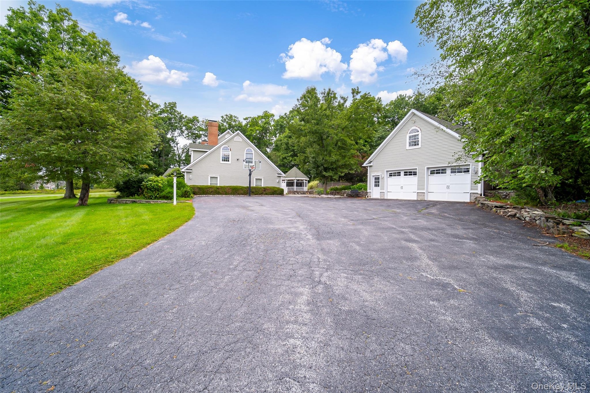 Expansive paved driveway with a separate detached two-car garage. Room for everyone!