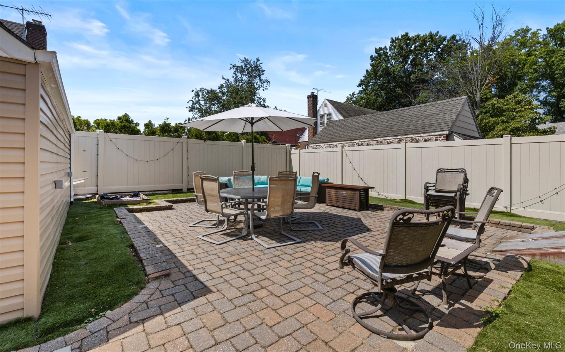 Fenced backyard featuring a patio area and outdoor dining space