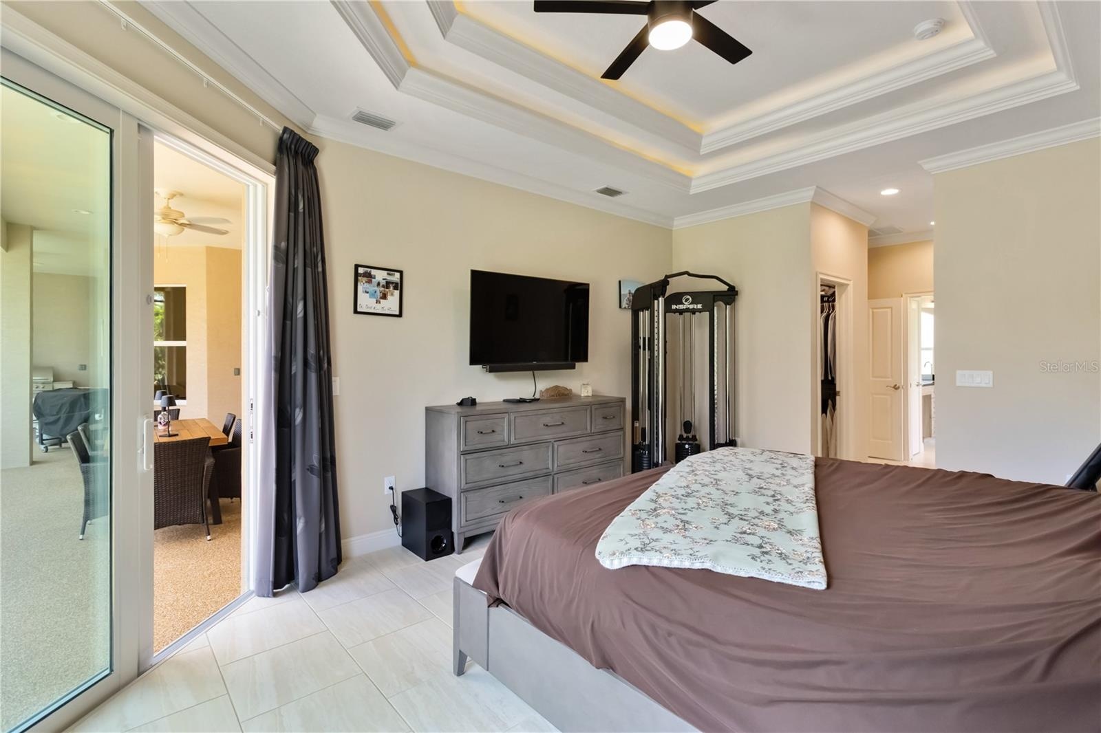 The hall leads to his and her closets then into the bathroom. Pocket doors separate the bathroom from the closet space. Notice the tray ceiling with l