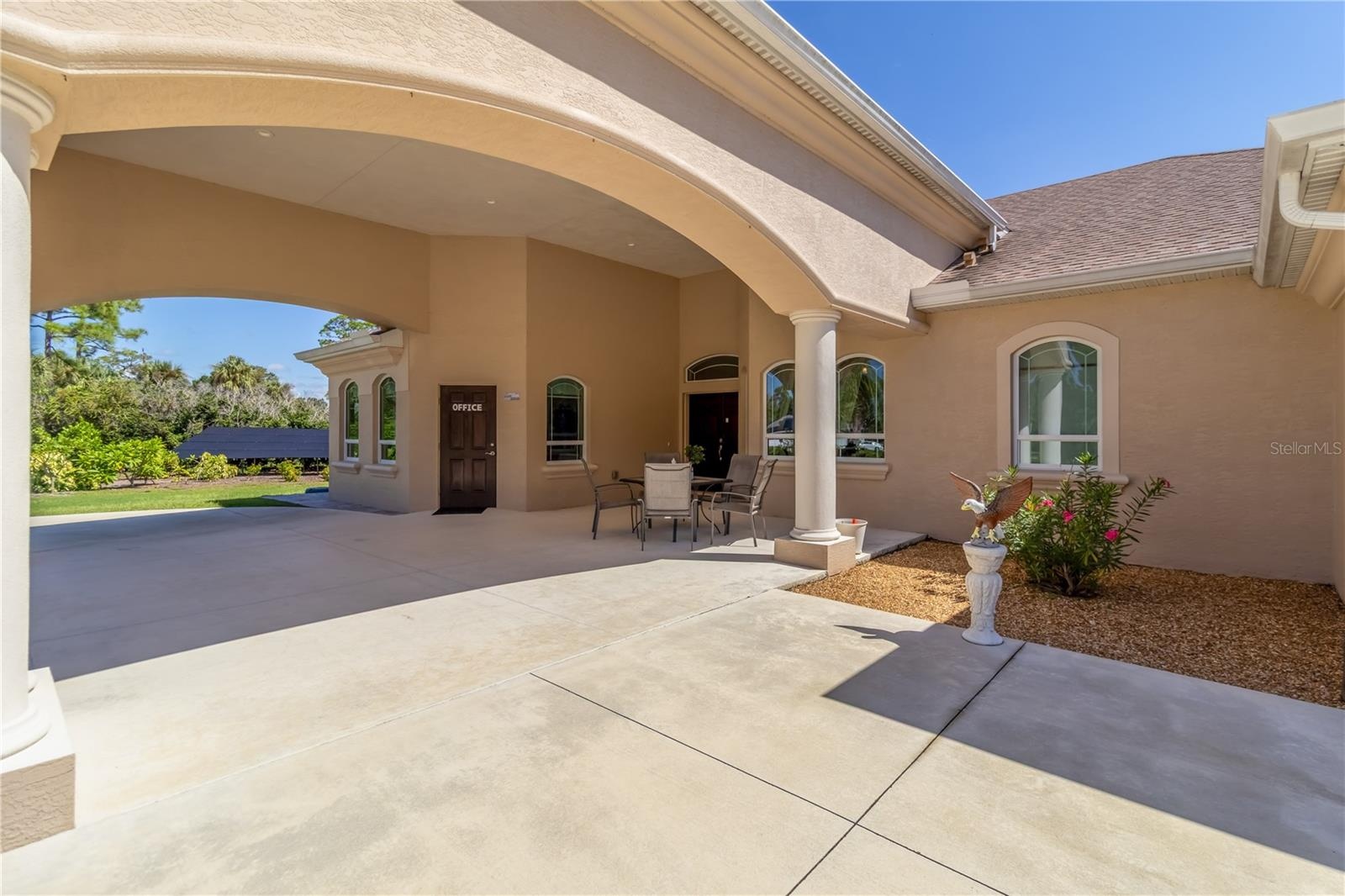 The parking arch not only protects you from the elements but adds a stately feel to the home. The door on the left leads to the dedicated office. The 