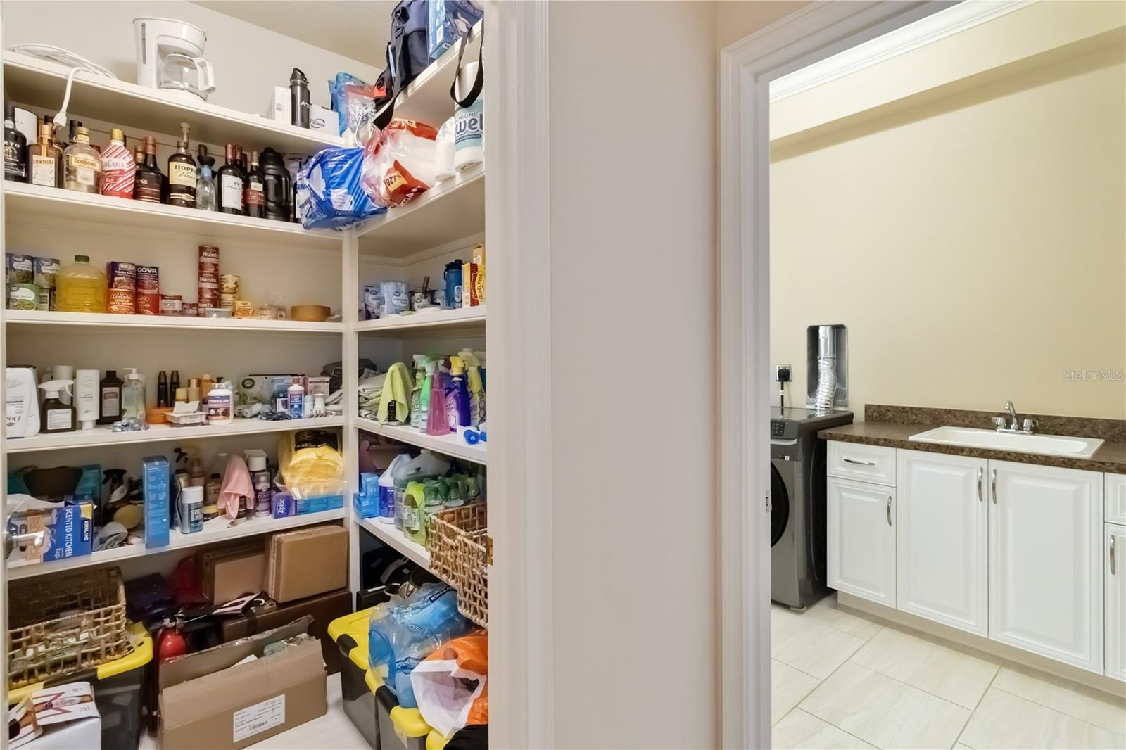 This walk-in pantry and laundry room are accessible through the arch in the previous picture of the kitchen.