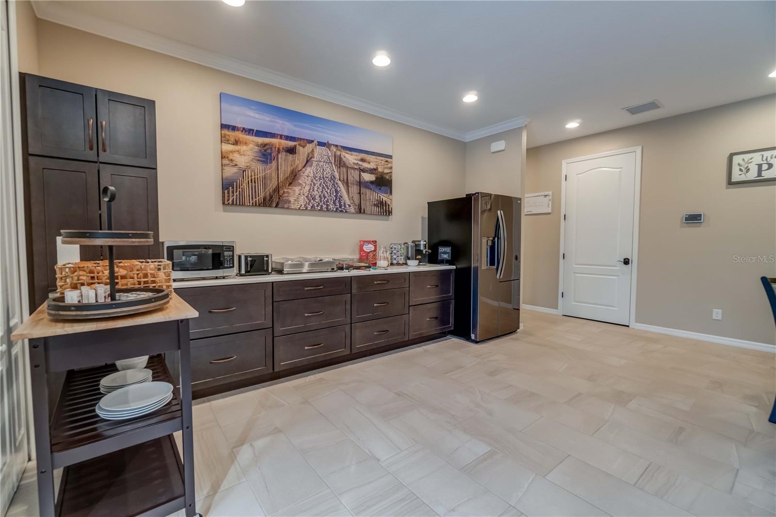 This is the other half of the gathering room and where the sellers served their guests breakfast each morning. The custom cabinets are maple. The coun