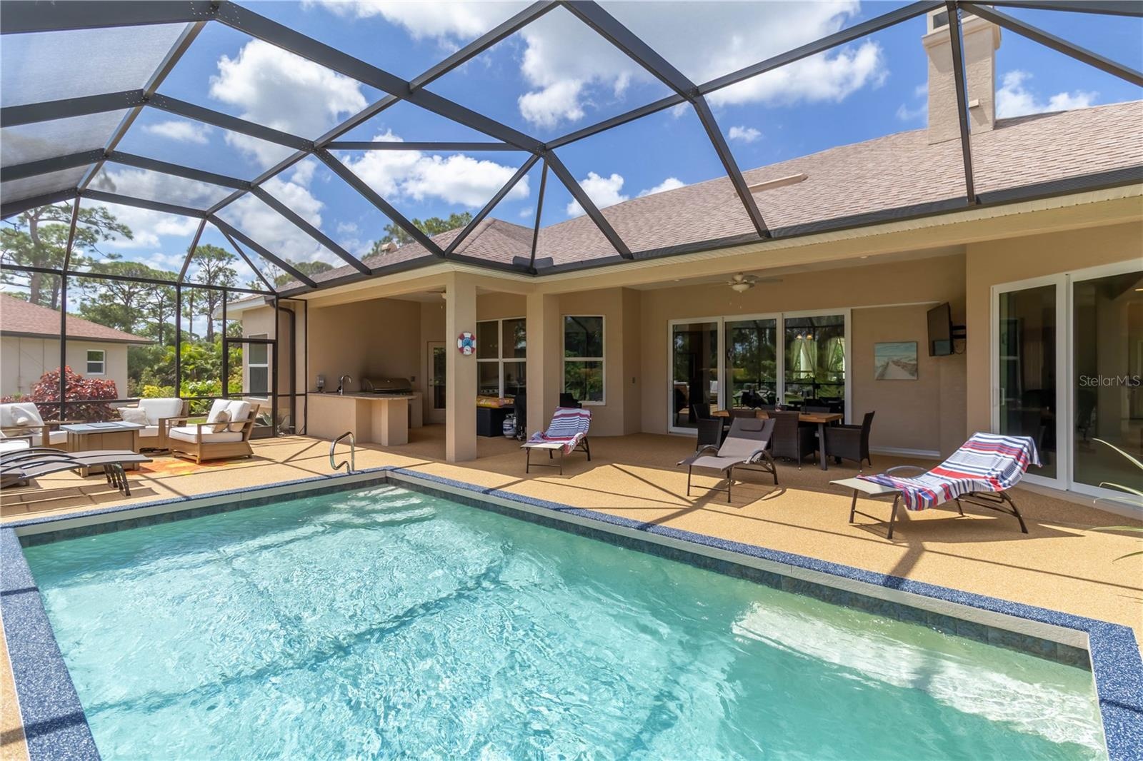 The pool area! This is a heated, saltwater pool. Notice the huge sliders that lead into the great room. Opening those fully really brings the outside 