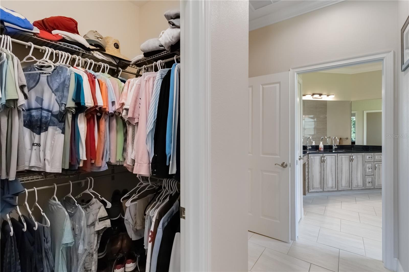 One of two closets in the primary bedroom. The door to the left leads to the great room. Pocket doors separate the primary bathroom from the rest of t