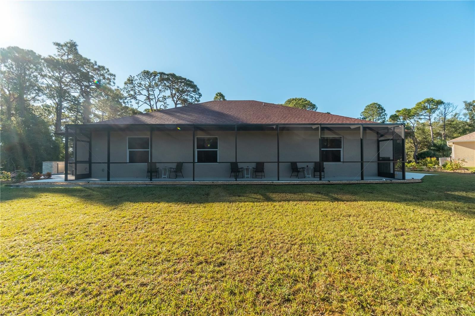 This is the lanai in the guest house mentioned earlier. The lanai overlooks the pond, fire pit and part of the yard. The three windows belong to suite