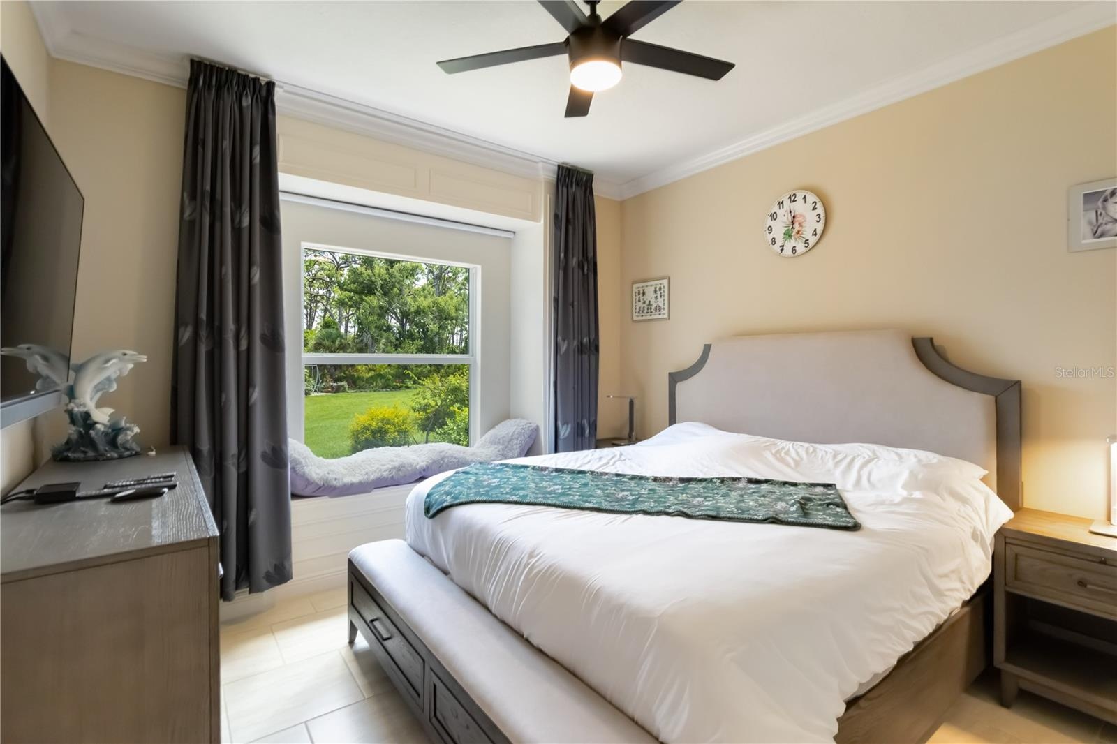 This is one of the two additional bedrooms in the main house. Notice the crown molding (throughout the home, window seat (and view!), ten foot ceiling