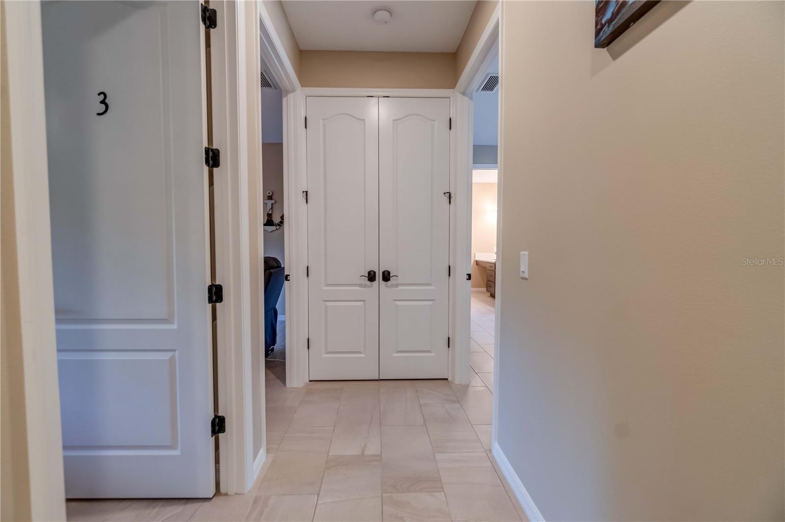 Another picture of the water heater closet. The three open doors lead to individual suites. They are numbered  for the convenience of the guests.