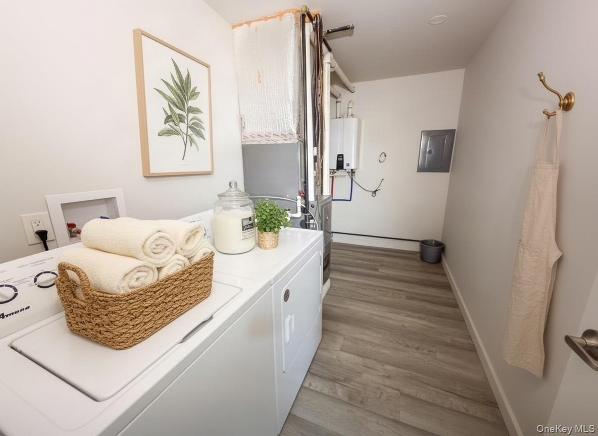 Virtually staged. Laundry area with side-by-side washer and dryer and hallway access.
