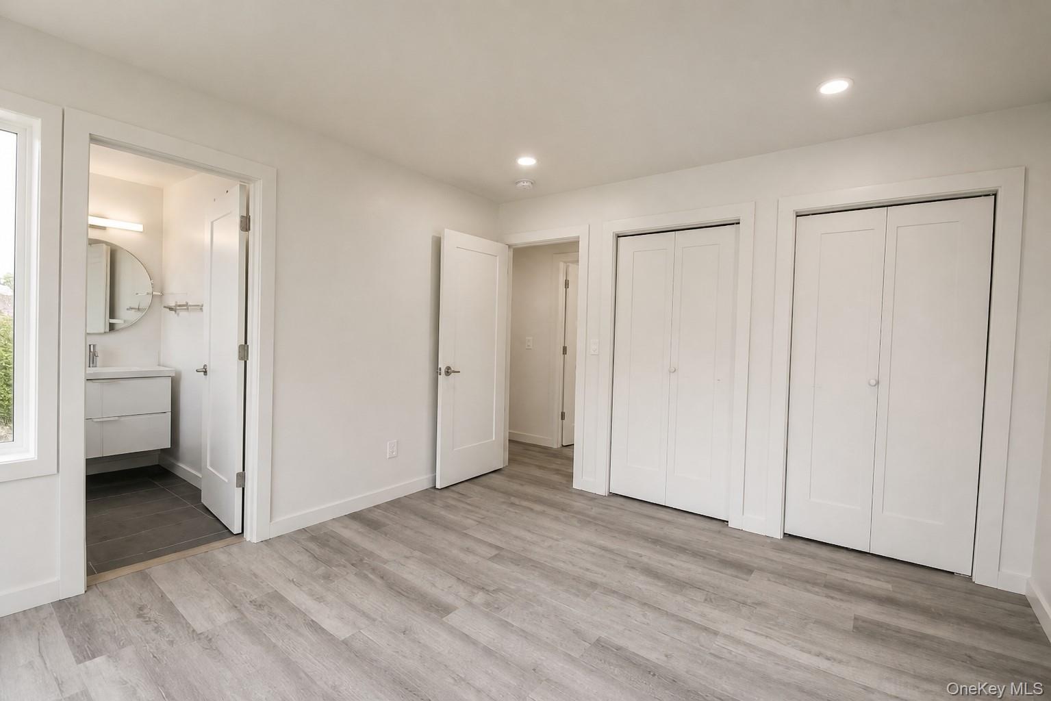 Primary bedroom with two closets and direct access to the bathroom.