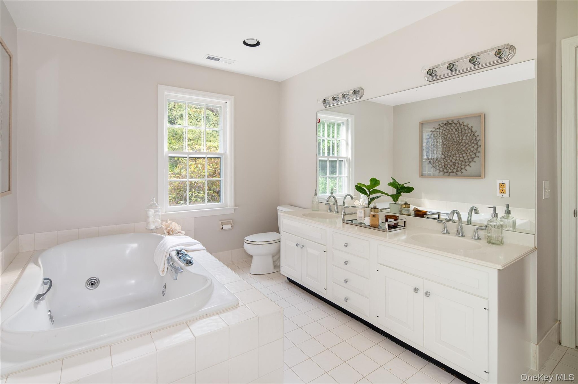 Large soaking tub, double vanity, & separate shower out of view
