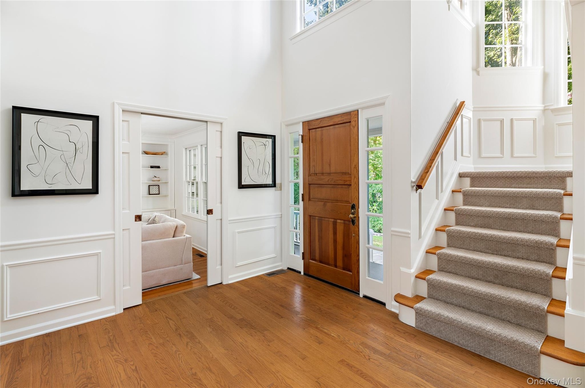 Generous foyer with pocket doors to family room, multiple windows and the unique turret with staircase to second floor