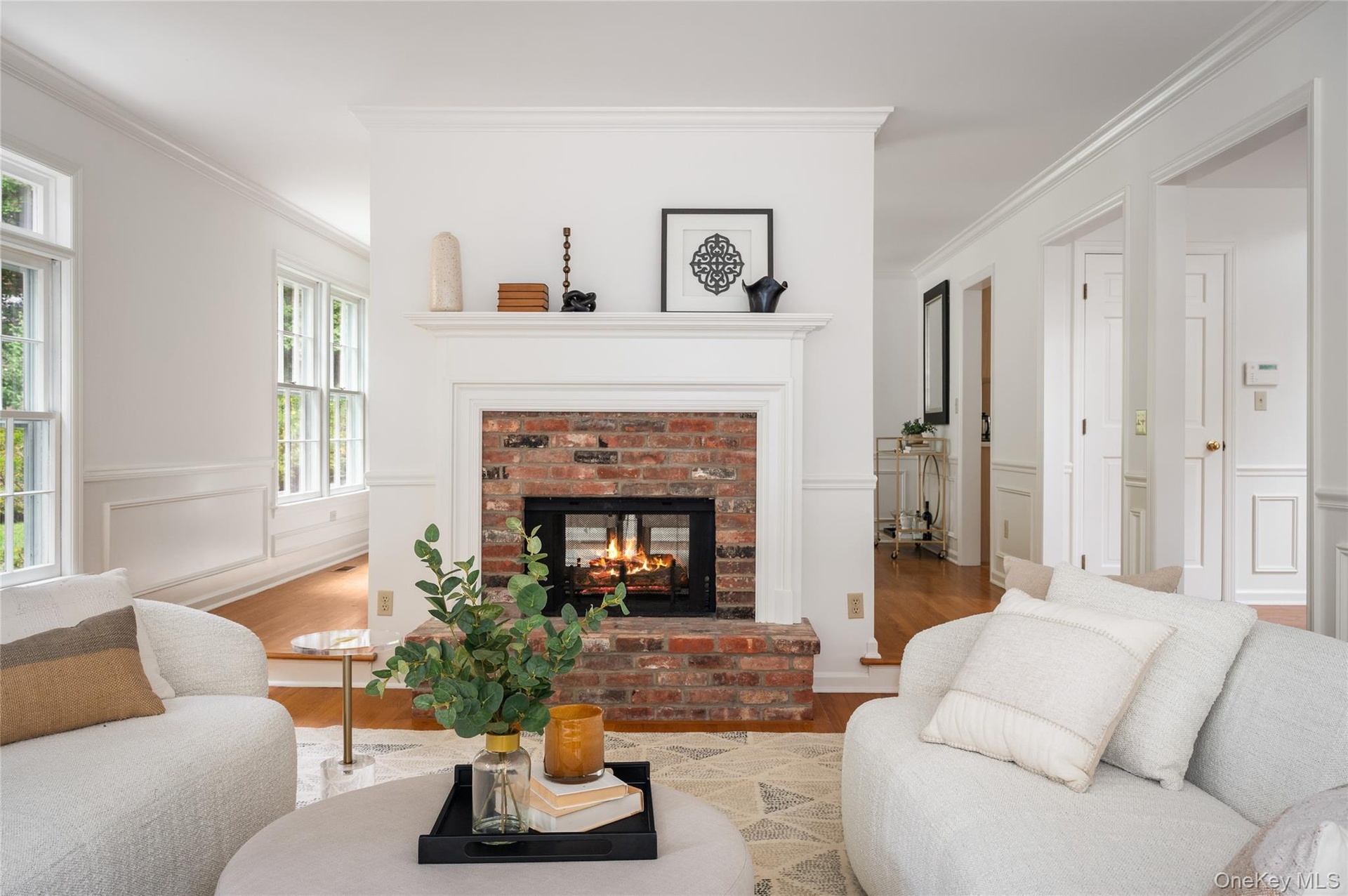 Formal living room with double sided fireplace, formal dinning room beyond