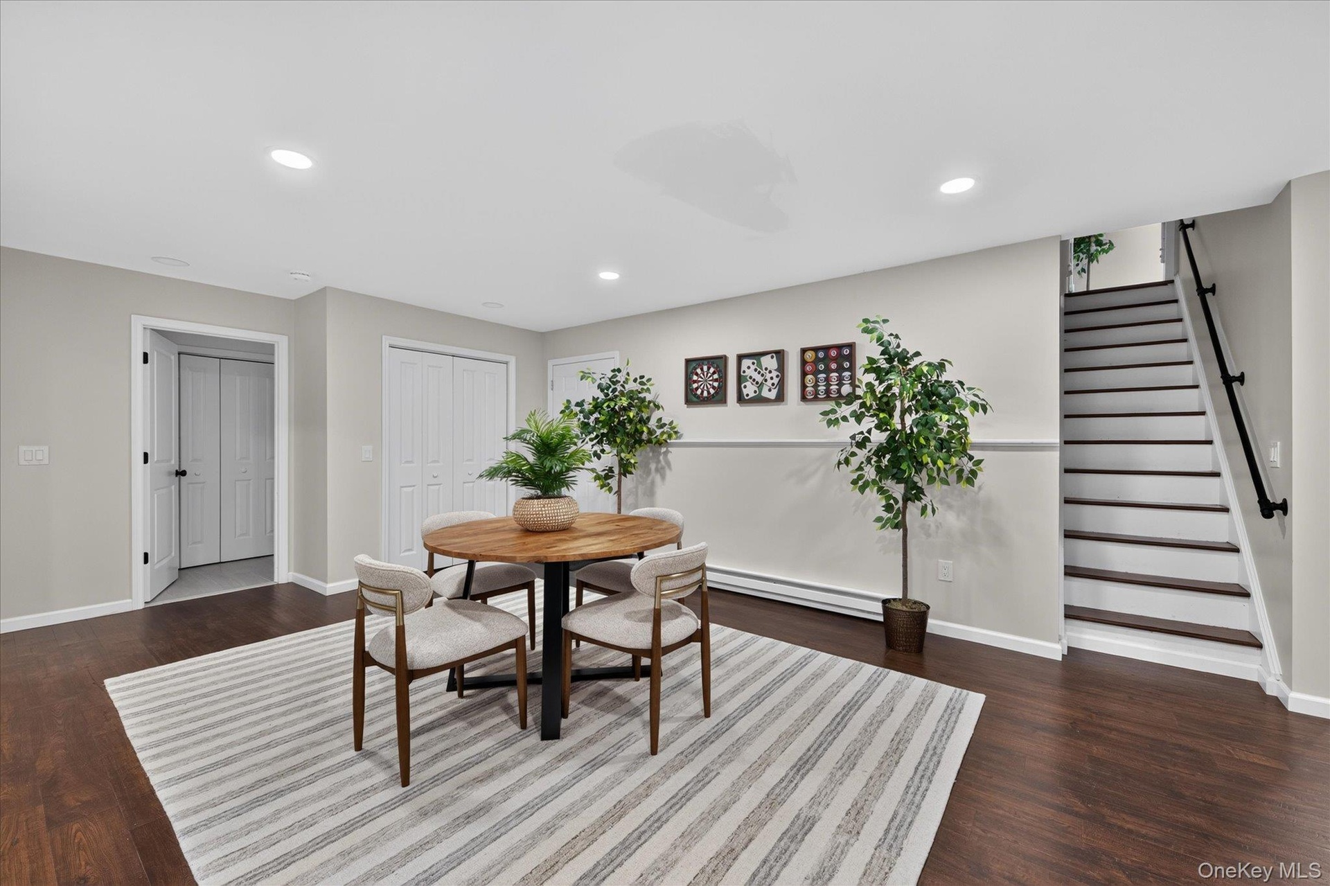 Lower-level-Recessed lighting illuminates wood-finish flooring and light gray walls