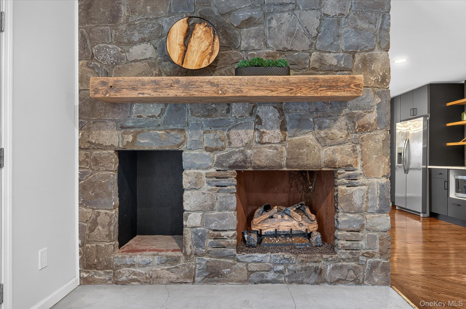 Stone fireplace with a substantial wood mantel