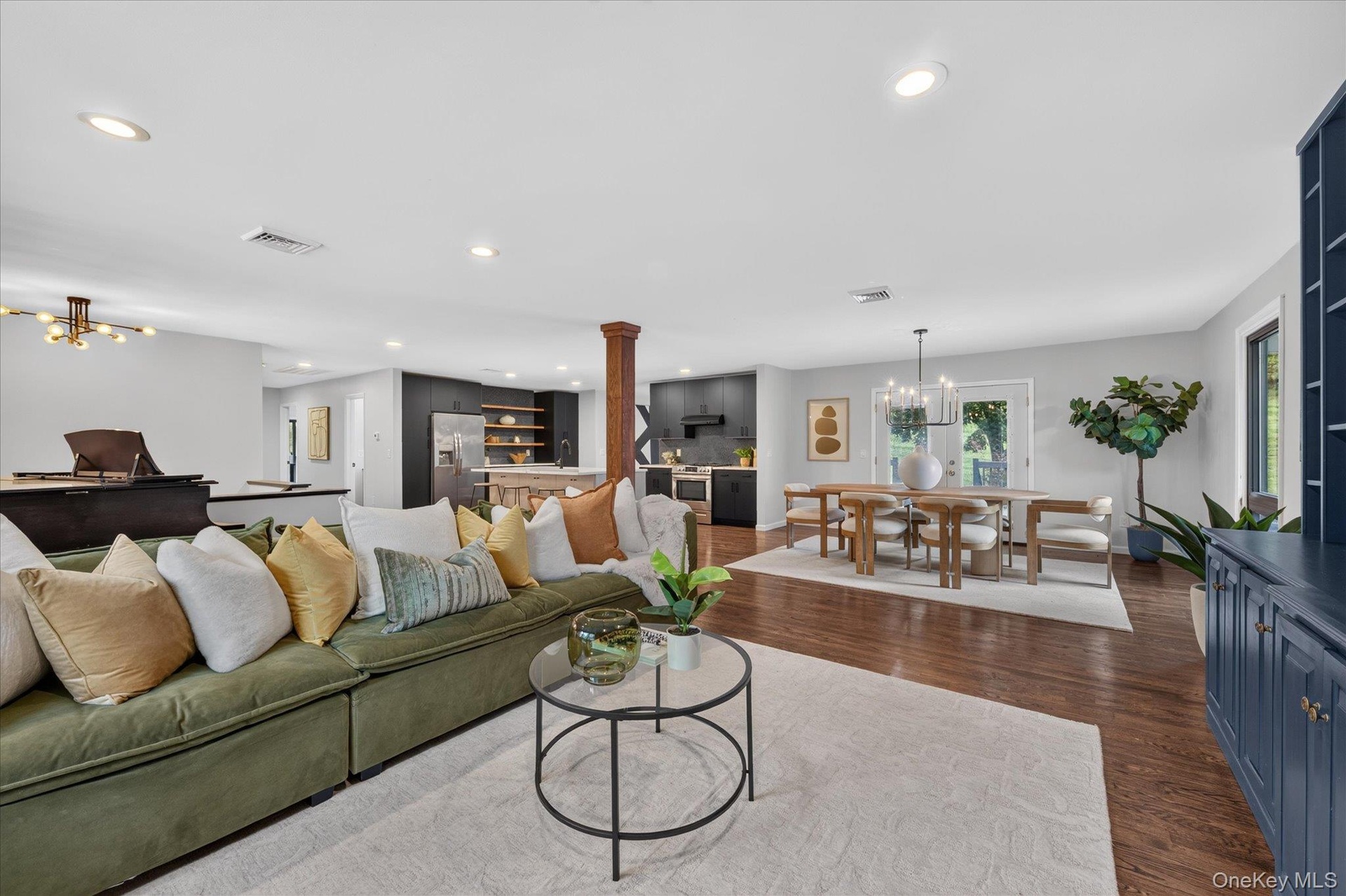Loft-like, Open floor plan--Hardwood flooring throughout, recessed lighting, and a chandelier-lit dining area