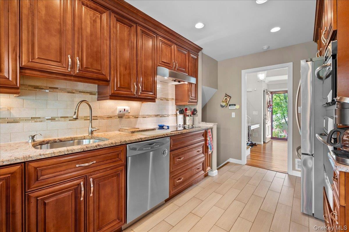 Kitchen with stainless steel appliances and soft close drawers and cabinets