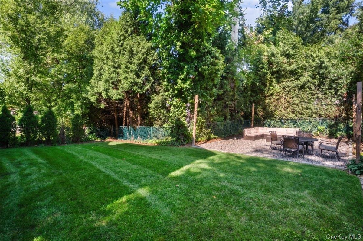 Private, flat backyard with separate firepit area