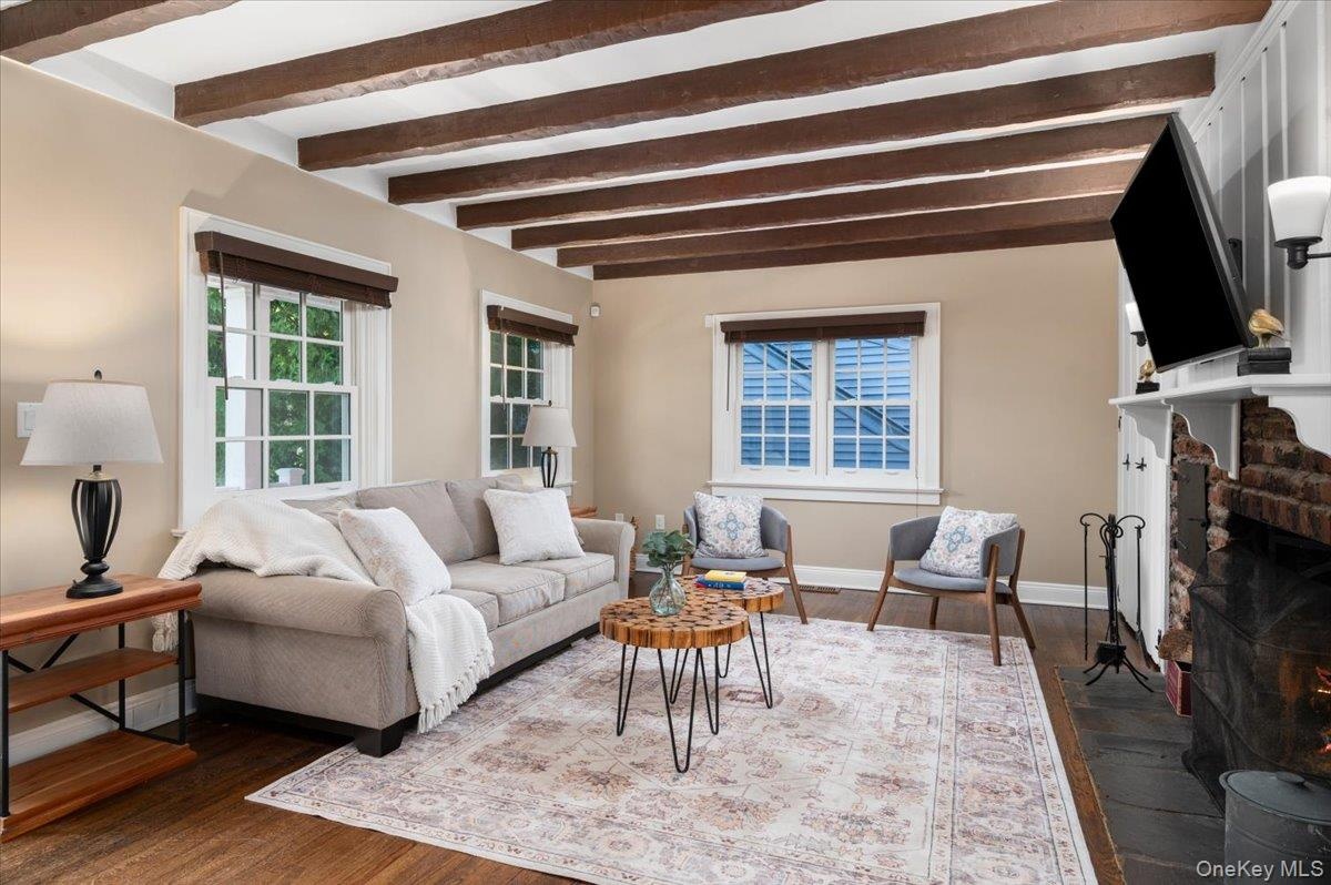 Front living room with original beams and woodburning fireplace