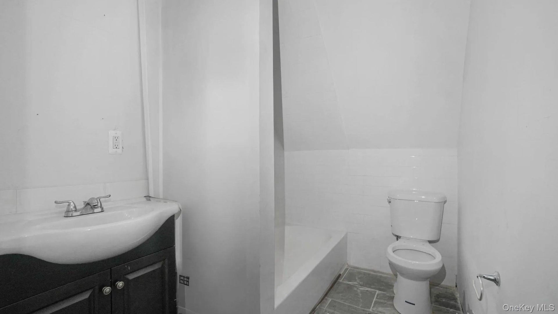 Bathroom with a tub to relax in, toilet, and vanity