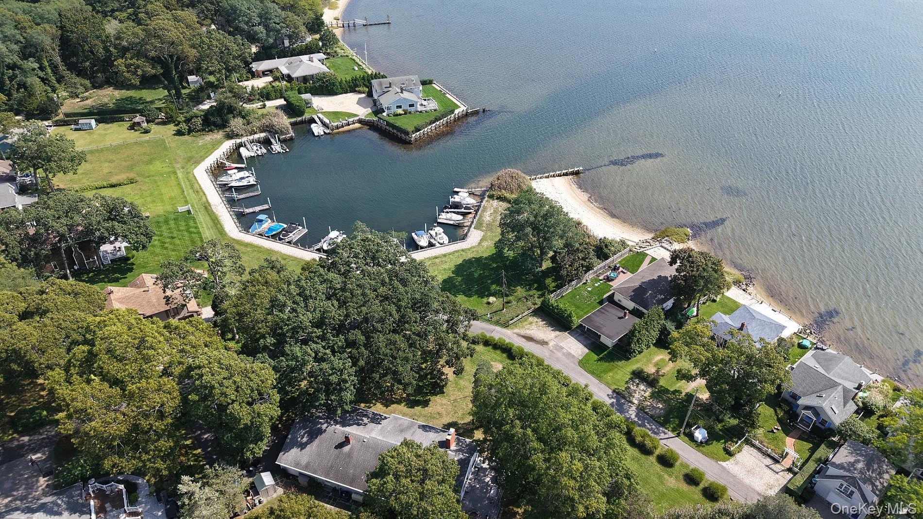 Aerial view of the marina, boat dock, and beach