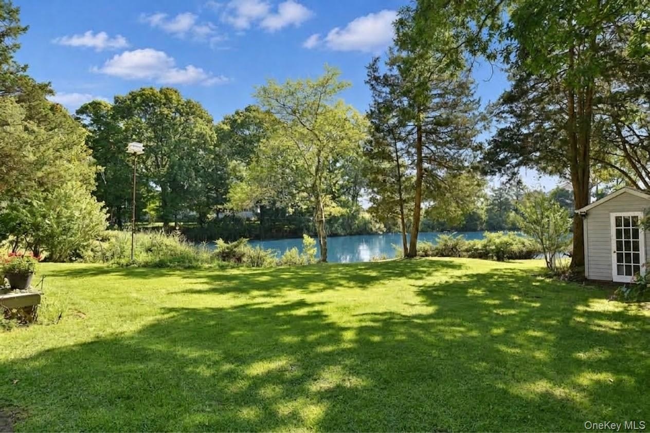 Large yard with gardens and a shed