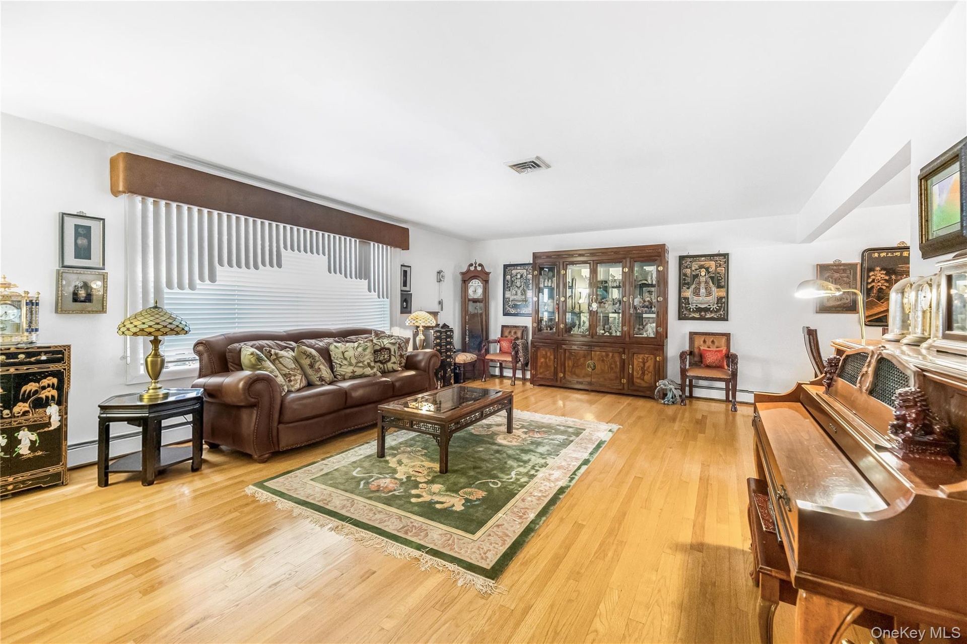 Light wood-finish flooring, white walls, and a multi-level floor plan with visible stairs