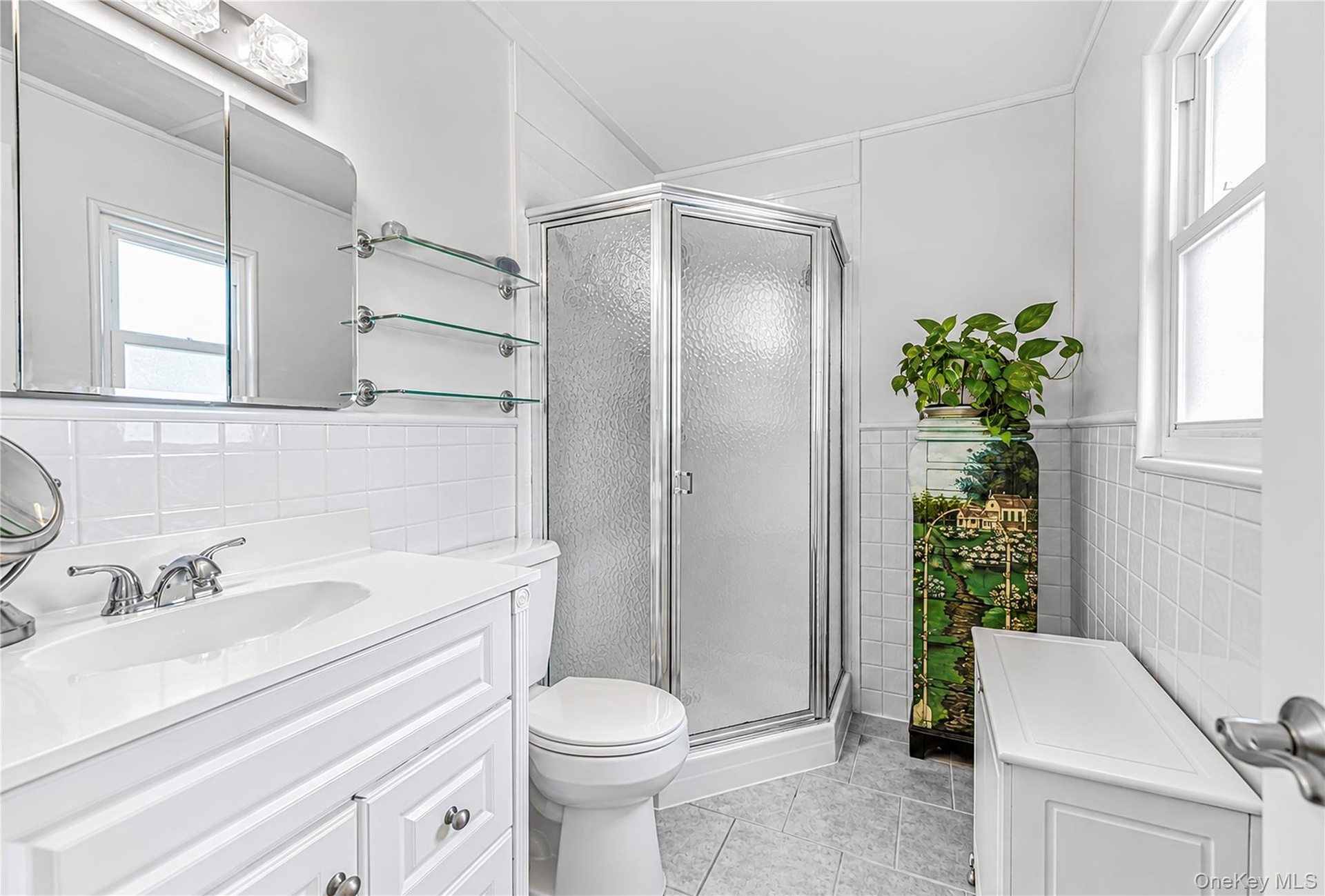 White vanity with integrated sink and chrome faucet