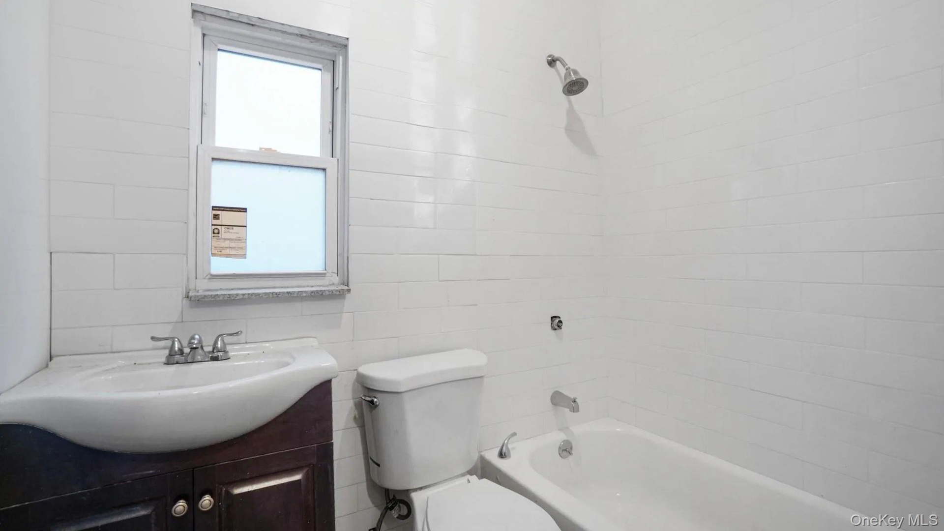Full bathroom featuring vanity, toilet, and tiled shower / bath combo