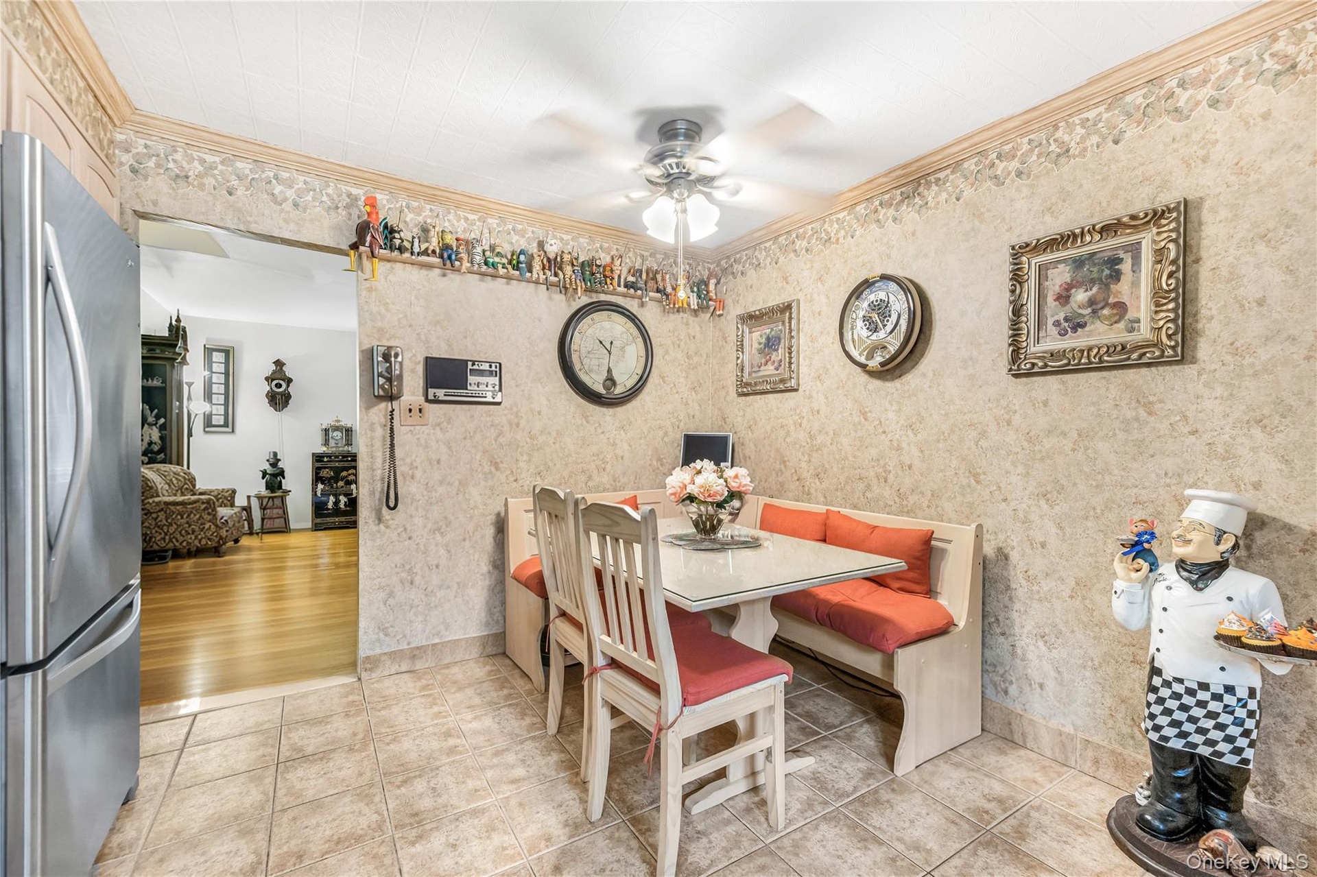 Kitchen featuring light-toned cabinetry, tile flooring, and stainless steel appliances