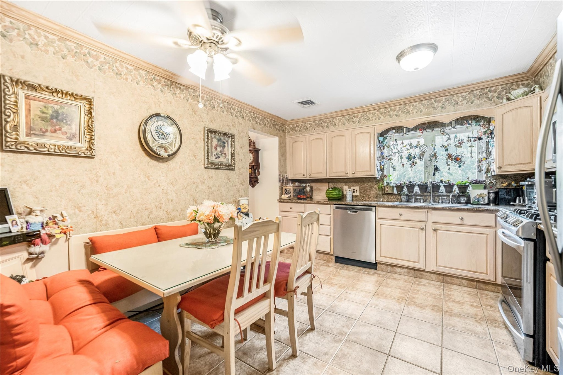 Kitchen featuring light-toned cabinetry, tile flooring, and stainless steel appliances