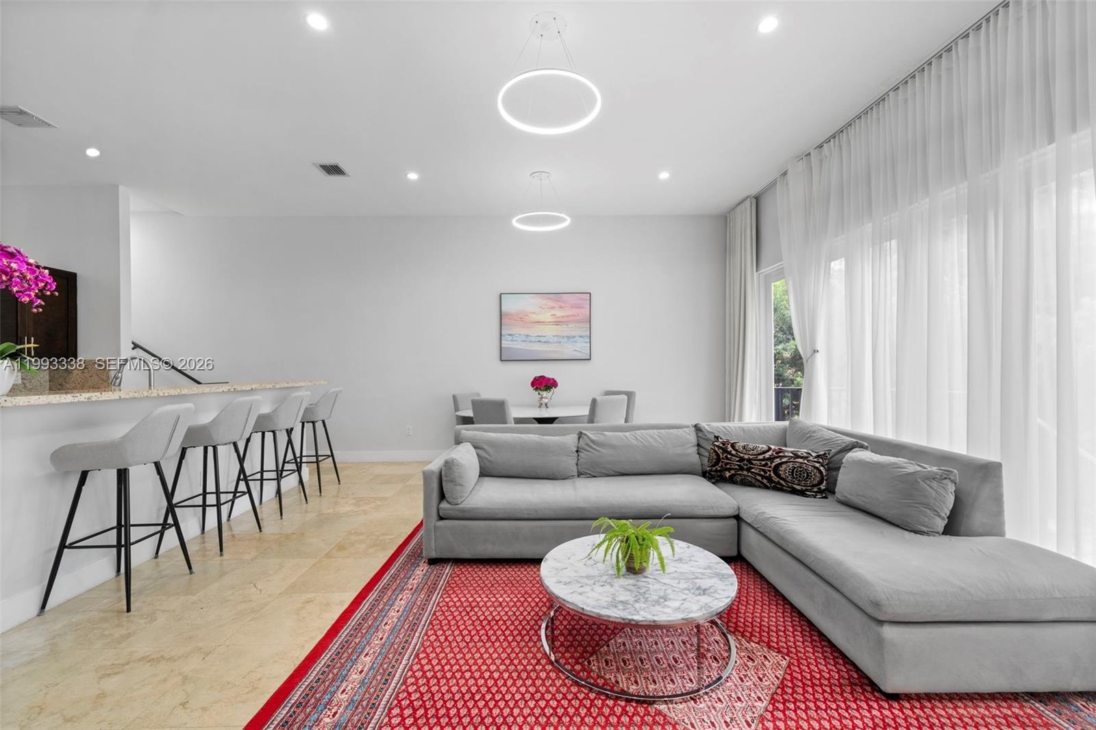 11-ft ceilings & floor-to-ceiling windows.