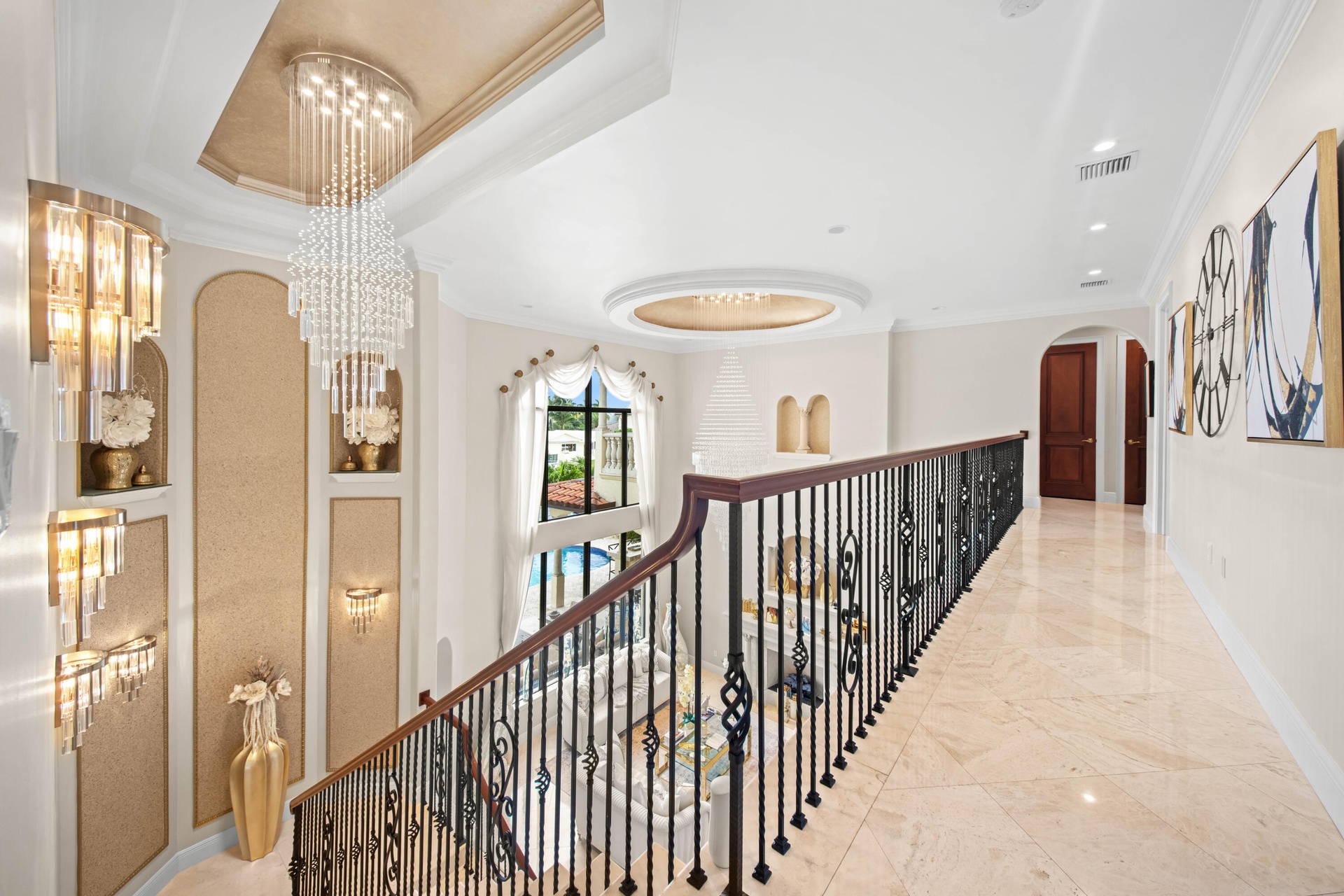Upper Level Gallery Walkway with Grand Overlook of living area and chandeliers