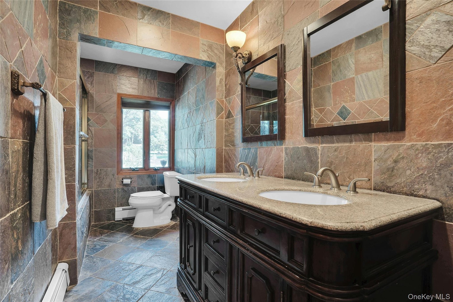 Beautifully updated bathroom with double sinks.