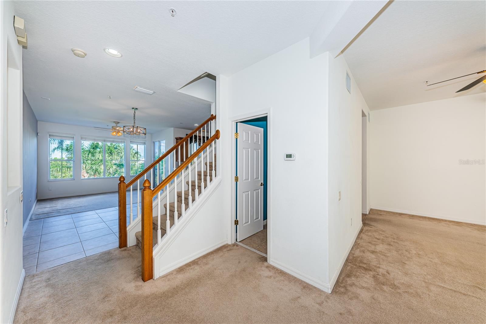 Stairway to bedroom level and a powder room outside the living room