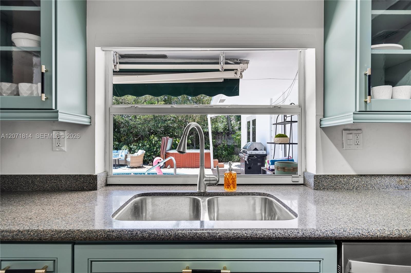 Sleek kitchen featuring quartz countertops and updated cabinetry