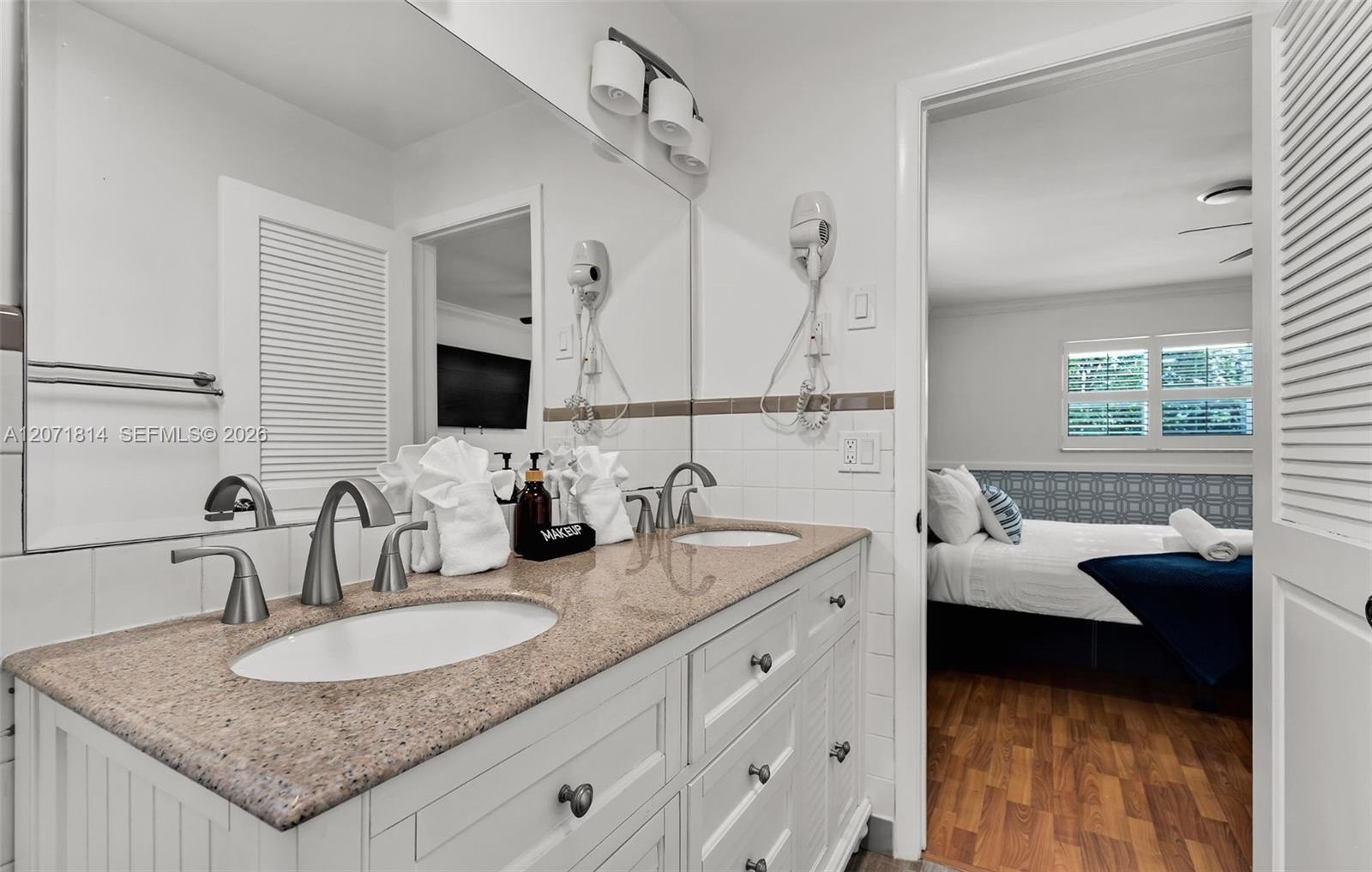 Elegant bathroom with dual vanity and granite countertops