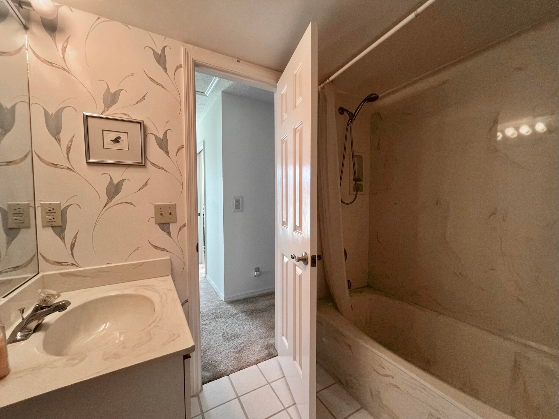 Bathroom featuring a built-in vanity with an integrated sink and a cultured marble countertop, a shower/tub combination with a wall-mounted shower hea