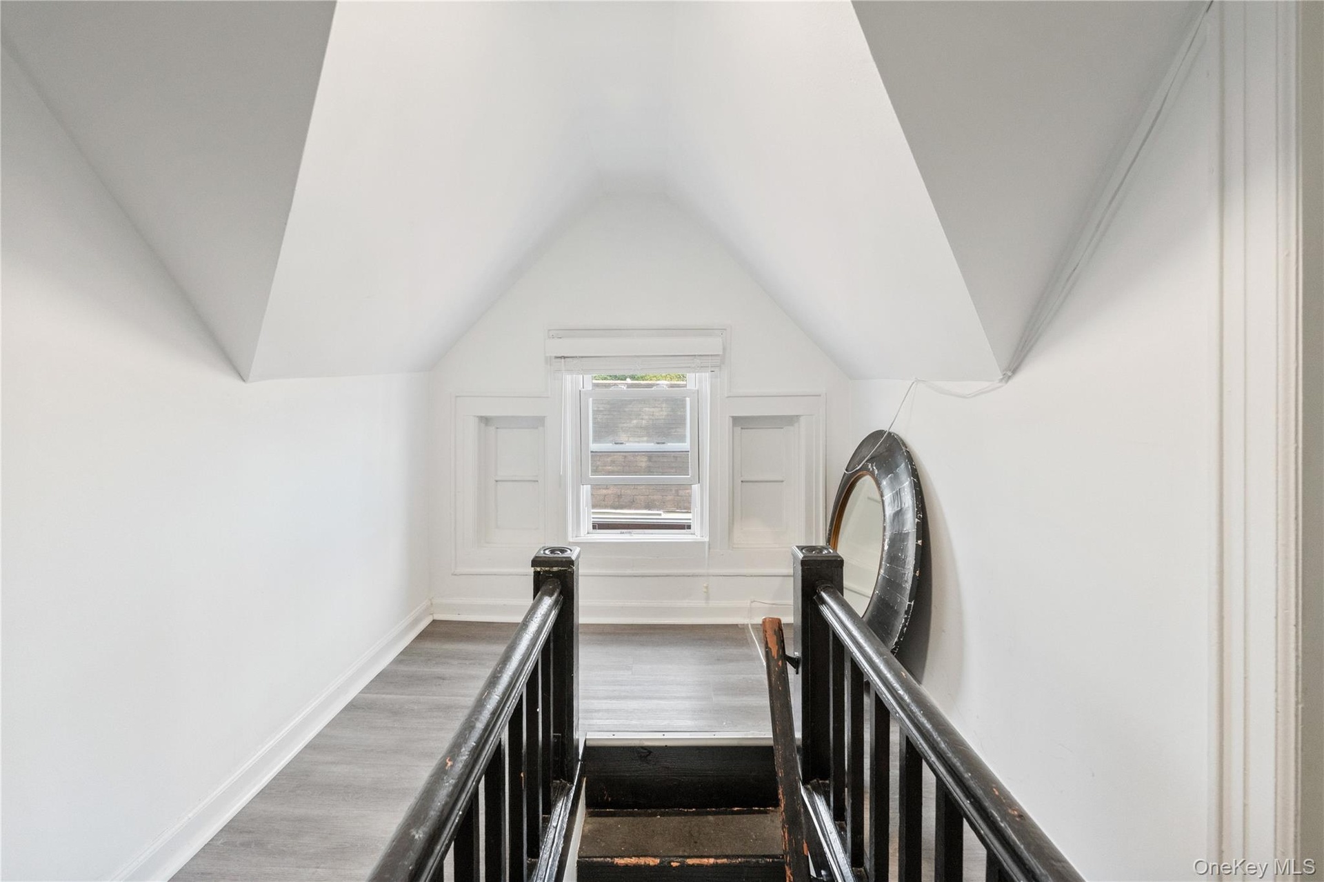 Cozy upper-level landing providing access to two additional rooms, offering a functional transition space with natural light. 2nd floor Unit.